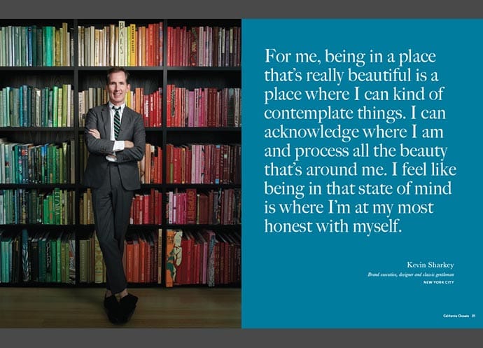 Kevin Sharkey standing in front of a color-organized bookshelf with a quote about beauty and self-reflection