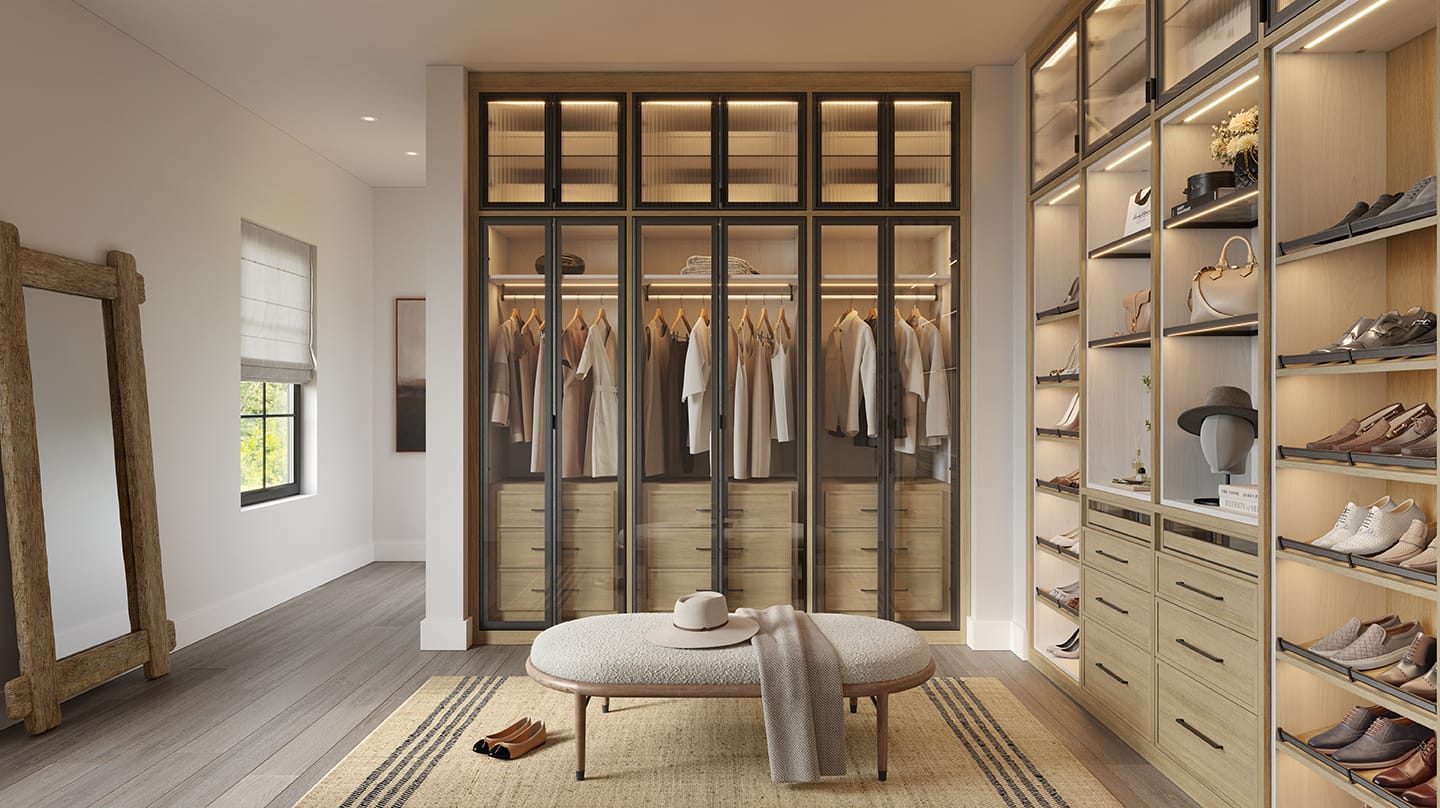Designed and professionally installed walk in closet with custom lighting, cabinetry and shoe storage by California Closets