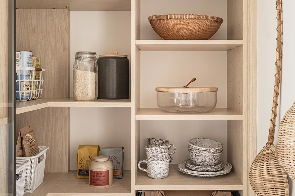 Corner pantry design with corner shelving and wrap shelves made by California Closets