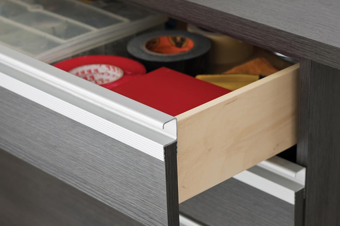 Custom cabinets for garage storage solutions with metal pulls by California Closets