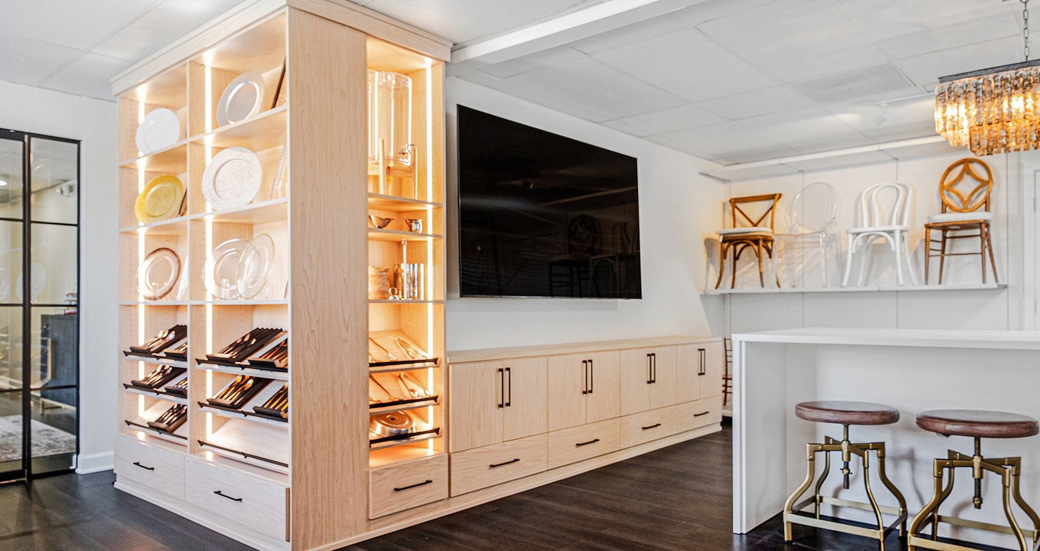Corner wrap shelving and cabinet storage for a showroom designed by California Closets