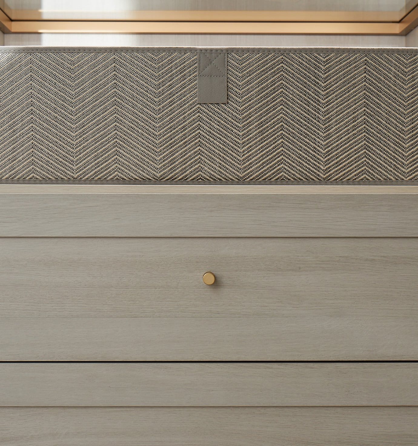 Custom closet drawers in a grey wood grain finish from California Closets