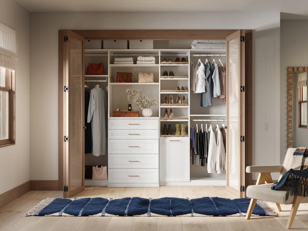 Custom closet system reach in design with tall shelving and built-in dresser drawers by California Closets